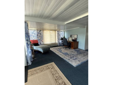 Indulge in expansive living within this magnificent double-wide on Hamptons Golf Club in Florida - for sale on GolfHomes.com, golf home, golf lot
