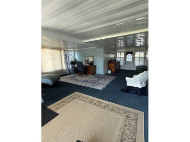Indulge in expansive living within this magnificent double-wide on Hamptons Golf Club in Florida - for sale on GolfHomes.com, golf home, golf lot