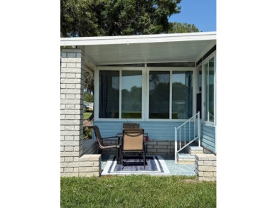 Indulge in expansive living within this magnificent double-wide on Hamptons Golf Club in Florida - for sale on GolfHomes.com, golf home, golf lot