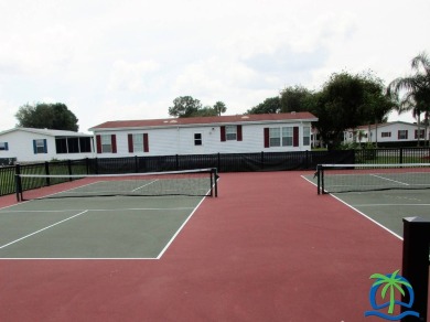 Indulge in expansive living within this magnificent double-wide on Hamptons Golf Club in Florida - for sale on GolfHomes.com, golf home, golf lot