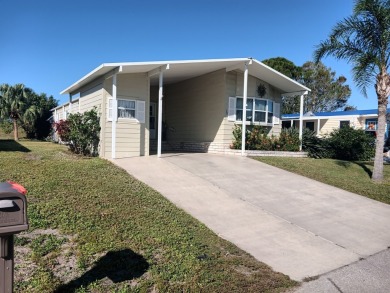 This 1988 offset double-wide home can fulfill your dreams of on Spanish Lakes Country Club in Florida - for sale on GolfHomes.com, golf home, golf lot