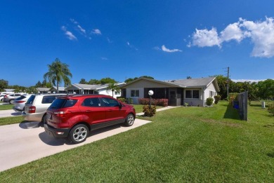 RARE HALF DUPLEX WITH PRIVATE BACKYARD! This 2-bedroom on Cypress Lakes Golf Course - West Palm Beach in Florida - for sale on GolfHomes.com, golf home, golf lot