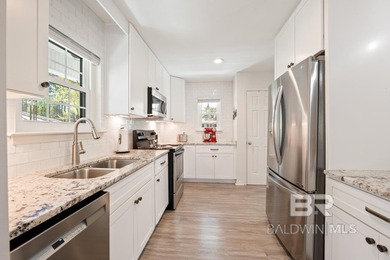 This charming, updated home with a wraparound front porch is on Lake Forest Yacht and Country Club in Alabama - for sale on GolfHomes.com, golf home, golf lot