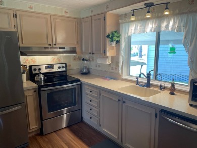 This lovely, manufactured home is in Lake Fairways Country Club on Pine Lakes Country Club in Florida - for sale on GolfHomes.com, golf home, golf lot