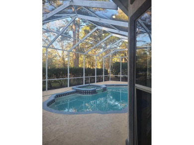 This 4-bedroom, 3.5 bathroom pool home backing to the green of on Turkey Creek Golf and Country Club in Florida - for sale on GolfHomes.com, golf home, golf lot