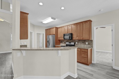 Welcome to this custom-built brick home with an open floor plan on Olde Point Golf and Country Club in North Carolina - for sale on GolfHomes.com, golf home, golf lot