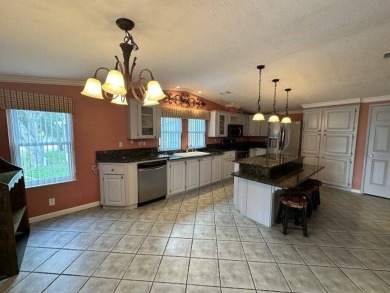 This beautiful triple-wide home, located on the golf course on Four Lakes Golf Club in Florida - for sale on GolfHomes.com, golf home, golf lot