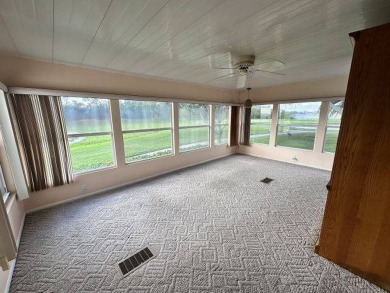 This beautiful triple-wide home, located on the golf course on Four Lakes Golf Club in Florida - for sale on GolfHomes.com, golf home, golf lot