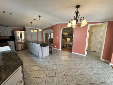 This beautiful triple-wide home, located on the golf course on Four Lakes Golf Club in Florida - for sale on GolfHomes.com, golf home, golf lot