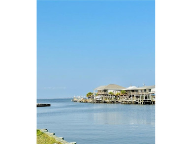 WATERFRONT ISLAND DREAM IN AN AMAZING LOCATION! Home has approx on Isle Dauphine Club Golf Course in AL - for sale on GolfHomes.com, golf home, golf lot