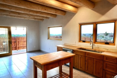 This is a remarkable custom home built in 2025 by renowned local on Taos Country Club in New Mexico - for sale on GolfHomes.com, golf home, golf lot