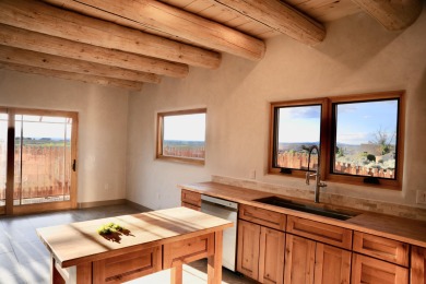This is a remarkable custom home built in 2025 by renowned local on Taos Country Club in New Mexico - for sale on GolfHomes.com, golf home, golf lot