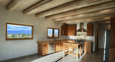 This is a remarkable custom home built in 2025 by renowned local on Taos Country Club in New Mexico - for sale on GolfHomes.com, golf home, golf lot