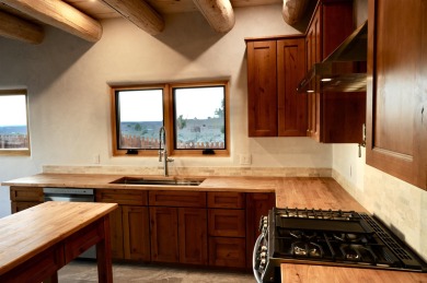 This is a remarkable custom home built in 2025 by renowned local on Taos Country Club in New Mexico - for sale on GolfHomes.com, golf home, golf lot