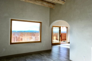 This is a remarkable custom home built in 2025 by renowned local on Taos Country Club in New Mexico - for sale on GolfHomes.com, golf home, golf lot
