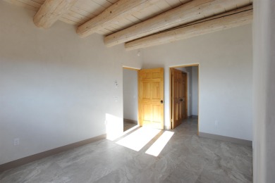 This is a remarkable custom home built in 2025 by renowned local on Taos Country Club in New Mexico - for sale on GolfHomes.com, golf home, golf lot
