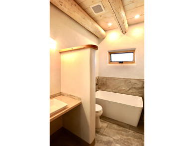 This is a remarkable custom home built in 2025 by renowned local on Taos Country Club in New Mexico - for sale on GolfHomes.com, golf home, golf lot