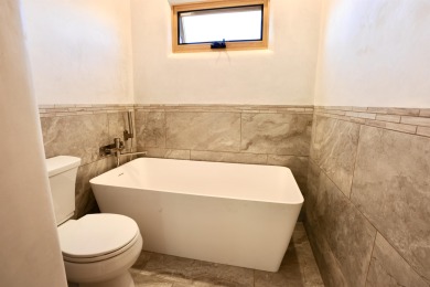 This is a remarkable custom home built in 2025 by renowned local on Taos Country Club in New Mexico - for sale on GolfHomes.com, golf home, golf lot