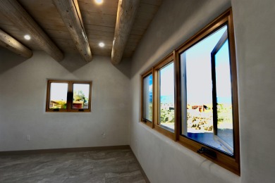 This is a remarkable custom home built in 2025 by renowned local on Taos Country Club in New Mexico - for sale on GolfHomes.com, golf home, golf lot
