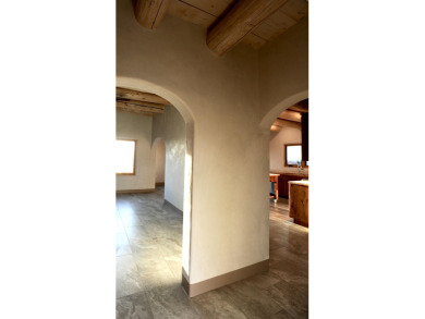This is a remarkable custom home built in 2025 by renowned local on Taos Country Club in New Mexico - for sale on GolfHomes.com, golf home, golf lot