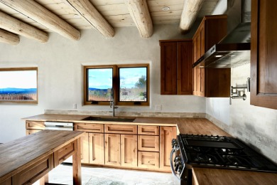 This is a remarkable custom home built in 2025 by renowned local on Taos Country Club in New Mexico - for sale on GolfHomes.com, golf home, golf lot