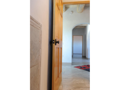 This is a remarkable custom home built in 2025 by renowned local on Taos Country Club in New Mexico - for sale on GolfHomes.com, golf home, golf lot