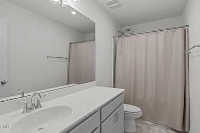 Greeted by a stacked-stone, covered front porch and classic on The Club At Twelve Oaks in North Carolina - for sale on GolfHomes.com, golf home, golf lot