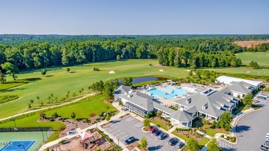 Greeted by a stacked-stone, covered front porch and classic on The Club At Twelve Oaks in North Carolina - for sale on GolfHomes.com, golf home, golf lot