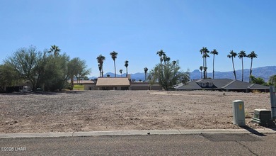 This exceptional vacant lot sits on a quiet, low-traffic road in on London Bridge Golf Course in Arizona - for sale on GolfHomes.com, golf home, golf lot