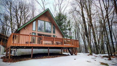 Escape to this cute-as-a-button 3-bedroom, 1-bath chalet with a on The Hideout Golf in Pennsylvania - for sale on GolfHomes.com, golf home, golf lot