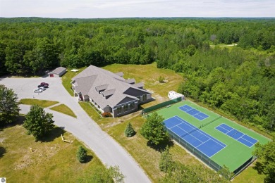 Discover 1.7 acres of beautifully wooded land, conveniently on Lakes of the North Deer Run Golf Course in Michigan - for sale on GolfHomes.com, golf home, golf lot