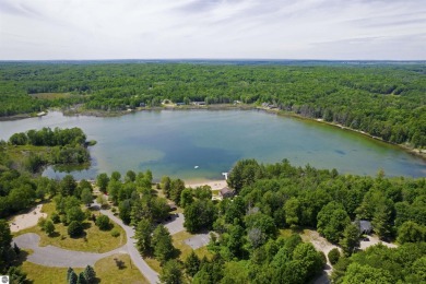 Discover 1.7 acres of beautifully wooded land, conveniently on Lakes of the North Deer Run Golf Course in Michigan - for sale on GolfHomes.com, golf home, golf lot