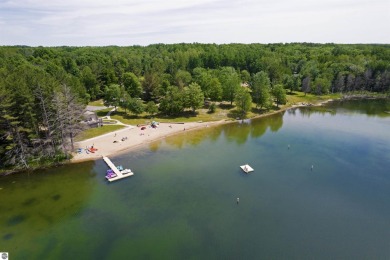 Discover 1.7 acres of beautifully wooded land, conveniently on Lakes of the North Deer Run Golf Course in Michigan - for sale on GolfHomes.com, golf home, golf lot