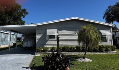 This well maintained 2 bedroom2 bath, 1988 Homes of Merit sits on Lake Henry Golf Club in Florida - for sale on GolfHomes.com, golf home, golf lot