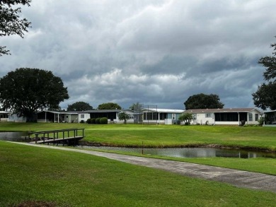 This well maintained 2 bedroom2 bath, 1988 Homes of Merit sits on Lake Henry Golf Club in Florida - for sale on GolfHomes.com, golf home, golf lot