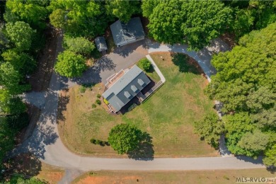 Enjoy main lake views and water-access living from this cape cod on Tanglewood Shores Golf Club in Virginia - for sale on GolfHomes.com, golf home, golf lot