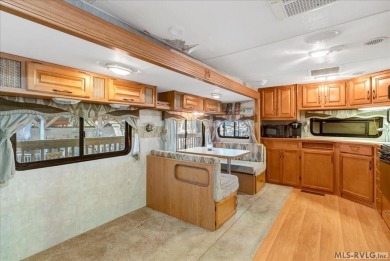 Lake life made easy--and fun! This Lake Gaston camper sits on a on River Ridge Golf Club in Virginia - for sale on GolfHomes.com, golf home, golf lot