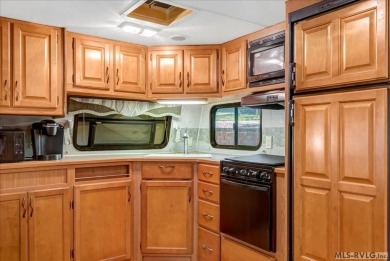 Lake life made easy--and fun! This Lake Gaston camper sits on a on River Ridge Golf Club in Virginia - for sale on GolfHomes.com, golf home, golf lot