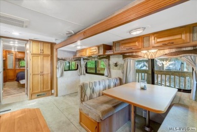 Lake life made easy--and fun! This Lake Gaston camper sits on a on River Ridge Golf Club in Virginia - for sale on GolfHomes.com, golf home, golf lot