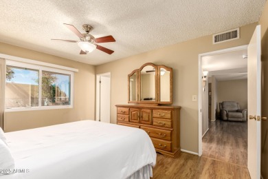 Nestled on a charming tree-lined street, this home offers on Sun City Lakes West and East in Arizona - for sale on GolfHomes.com, golf home, golf lot