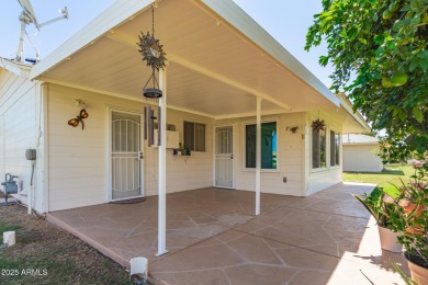 Nestled on a charming tree-lined street, this home offers on Sun City Lakes West and East in Arizona - for sale on GolfHomes.com, golf home, golf lot