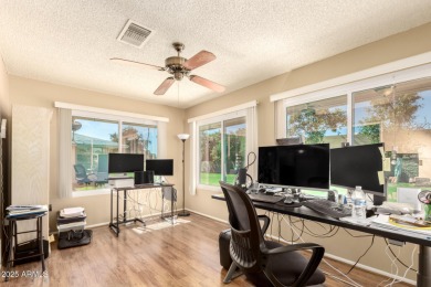 Nestled on a charming tree-lined street, this home offers on Sun City Lakes West and East in Arizona - for sale on GolfHomes.com, golf home, golf lot