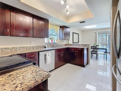 Welcome to this spacious 4-bedroom, 2-bathroom corner-unit villa on East Lake Woodlands Country Club in Florida - for sale on GolfHomes.com, golf home, golf lot