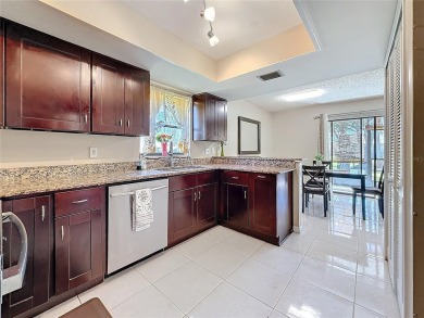 Welcome to this spacious 4-bedroom, 2-bathroom corner-unit villa on East Lake Woodlands Country Club in Florida - for sale on GolfHomes.com, golf home, golf lot