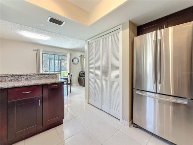 Welcome to this spacious 4-bedroom, 2-bathroom corner-unit villa on East Lake Woodlands Country Club in Florida - for sale on GolfHomes.com, golf home, golf lot