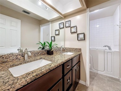 Welcome to this spacious 4-bedroom, 2-bathroom corner-unit villa on East Lake Woodlands Country Club in Florida - for sale on GolfHomes.com, golf home, golf lot