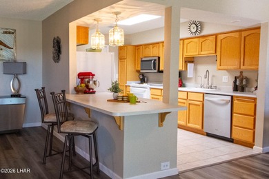 The spacious open floor plan allows you to enjoy the green on London Bridge Golf Course in Arizona - for sale on GolfHomes.com, golf home, golf lot