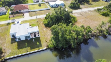 Discover waterfront bliss at 1908 NW 28th PL in Cape Coral, FL! on Coral Oaks Golf Course in Florida - for sale on GolfHomes.com, golf home, golf lot