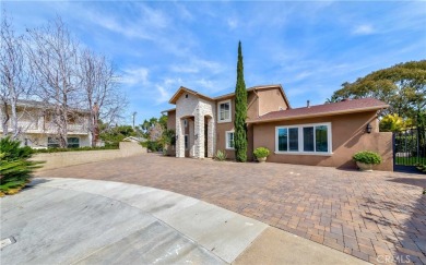 A paved driveway and elegant entrance welcome you to this on Newport Beach Golf Course in California - for sale on GolfHomes.com, golf home, golf lot