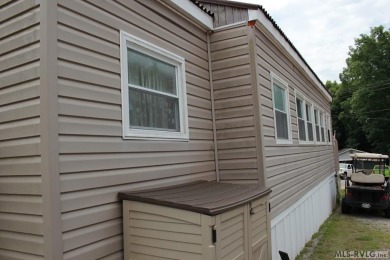 Check out this fully furnished 1994 camper with addition built on River Ridge Golf Club in Virginia - for sale on GolfHomes.com, golf home, golf lot